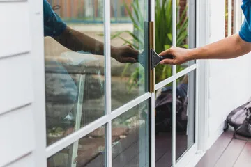 Technician installing window film on a home glass door